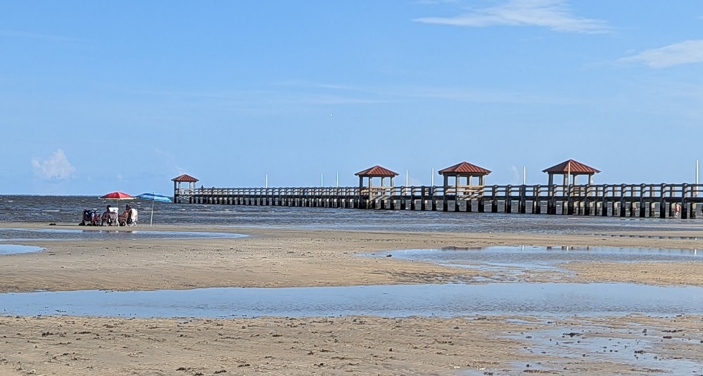 View of the pier and beach directly across from Gulf Haven RV Campground